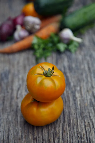 Fresh organic yellow tomatoes. Eco friendly non-gmo yellow tomatoes on the table. The concept of health, non-gmo products, clean ecological food. 