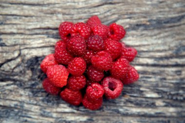 Fresh organic red raspberries. Composition with non-gmo red raspberries on the table. The concept of health, non-gmo products, clean ecological food. 