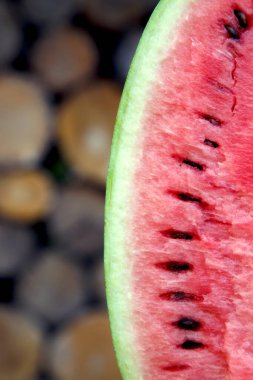 Juicy fresh red watermelon on the table. Watermelon sliced into pieces on a wooden texture background. The concept of food, happiness, sweets and desserts. 