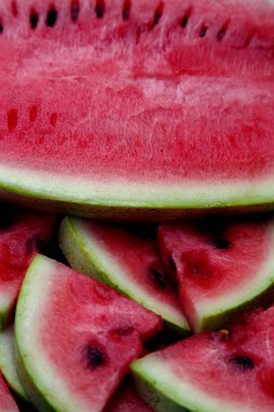 Juicy fresh red watermelon on the table. Watermelon sliced into pieces on a wooden texture background. The concept of food, happiness, sweets and desserts. 