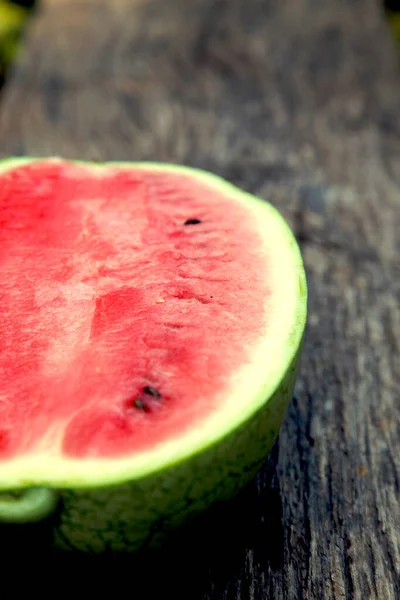 Juicy fresh red watermelon on the table. Watermelon sliced into pieces on a wooden texture background. The concept of food, happiness, sweets and desserts. 