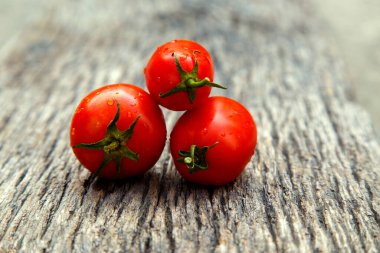 Fresh organic red tomatoes. Eco friendly non-gmo red tomatoes on the table. The concept of health, non-gmo products, clean ecological food. 