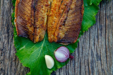 Sea fish cooked on the barbecue. Sea fish fillet baked on the grill. The concept of folk cuisine, restaurant, cooking. 