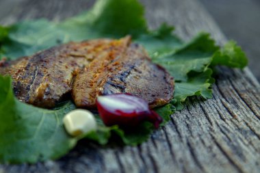 Sea fish cooked on the barbecue. Sea fish fillet baked on the grill. The concept of folk cuisine, restaurant, cooking. 