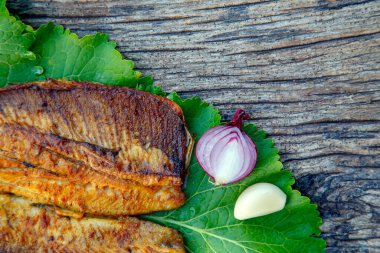 Sea fish cooked on the barbecue. Sea fish fillet baked on the grill. The concept of folk cuisine, restaurant, cooking. 