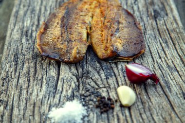 Sea fish cooked on the barbecue. Sea fish fillet baked on the grill. The concept of folk cuisine, restaurant, cooking. 