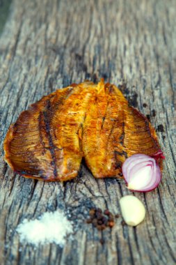 Sea fish cooked on the barbecue. Sea fish fillet baked on the grill. The concept of folk cuisine, restaurant, cooking. 