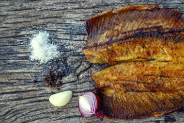 Sea fish cooked on the barbecue. Sea fish fillet baked on the grill. The concept of folk cuisine, restaurant, cooking. 