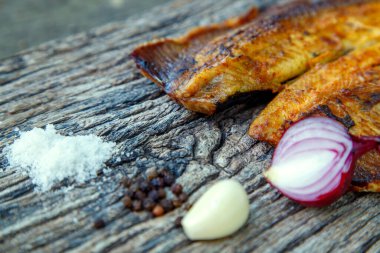 Sea fish cooked on the barbecue. Sea fish fillet baked on the grill. The concept of folk cuisine, restaurant, cooking. 