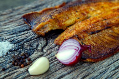 Sea fish cooked on the barbecue. Sea fish fillet baked on the grill. The concept of folk cuisine, restaurant, cooking. 