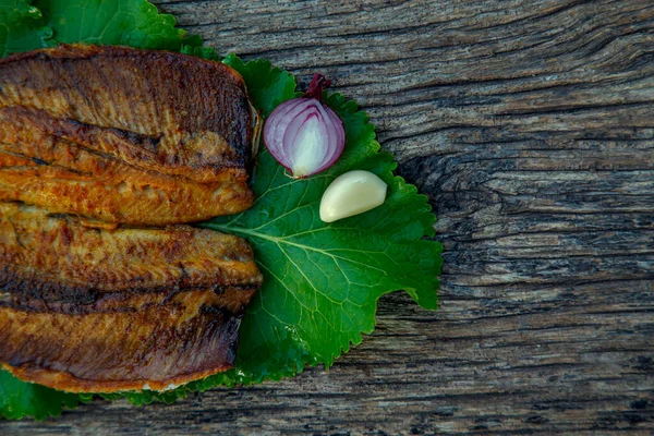 Sea fish cooked on the barbecue. Sea fish fillet baked on the grill. The concept of folk cuisine, restaurant, cooking. 