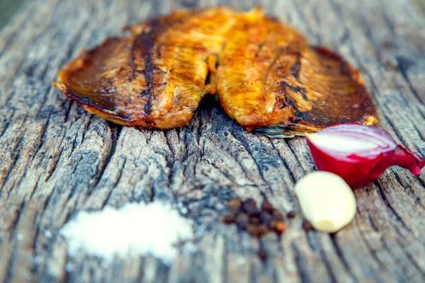 Sea fish cooked on the barbecue. Sea fish fillet baked on the grill. The concept of folk cuisine, restaurant, cooking. 