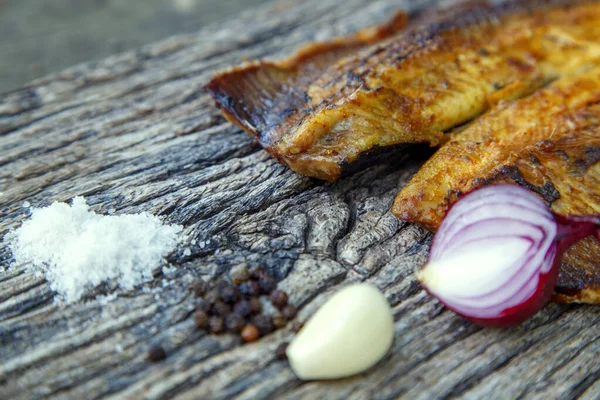 Sea fish cooked on the barbecue. Sea fish fillet baked on the grill. The concept of folk cuisine, restaurant, cooking. 