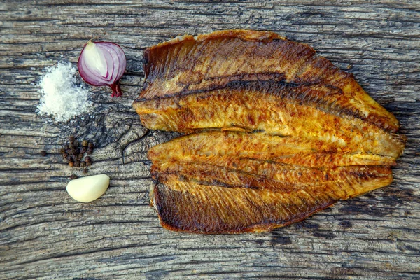 Sea fish cooked on the barbecue. Sea fish fillet baked on the grill. The concept of folk cuisine, restaurant, cooking.