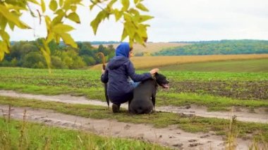Bir kadın fırtınadan sonra köpeğini tarlada gezdirir. Bulutlu bir günde doğada çalışan bir teriyeri olan bir kız. Özgürlük, mutluluk, arkadaşlık, doğa kavramı. Kamera hareketi. 