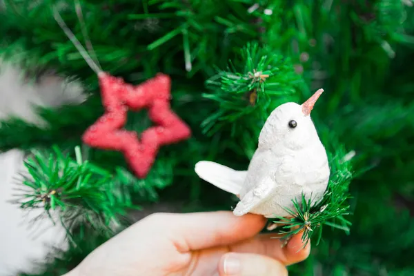 Bird decoration on artificial christmas tree — Stock Photo, Image