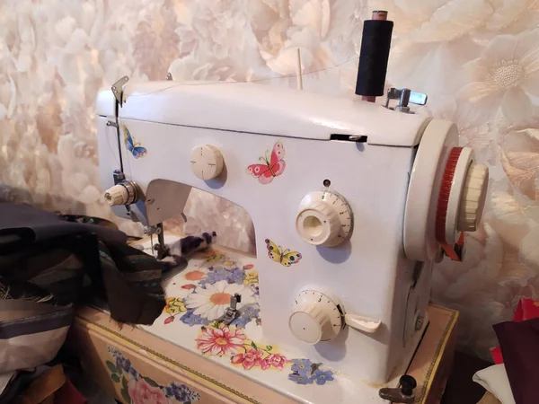 Tailor home work on sewing machine. Handmade fashion equipment.