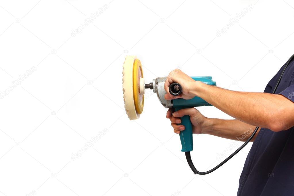 Man holds the Machine polisher for car care