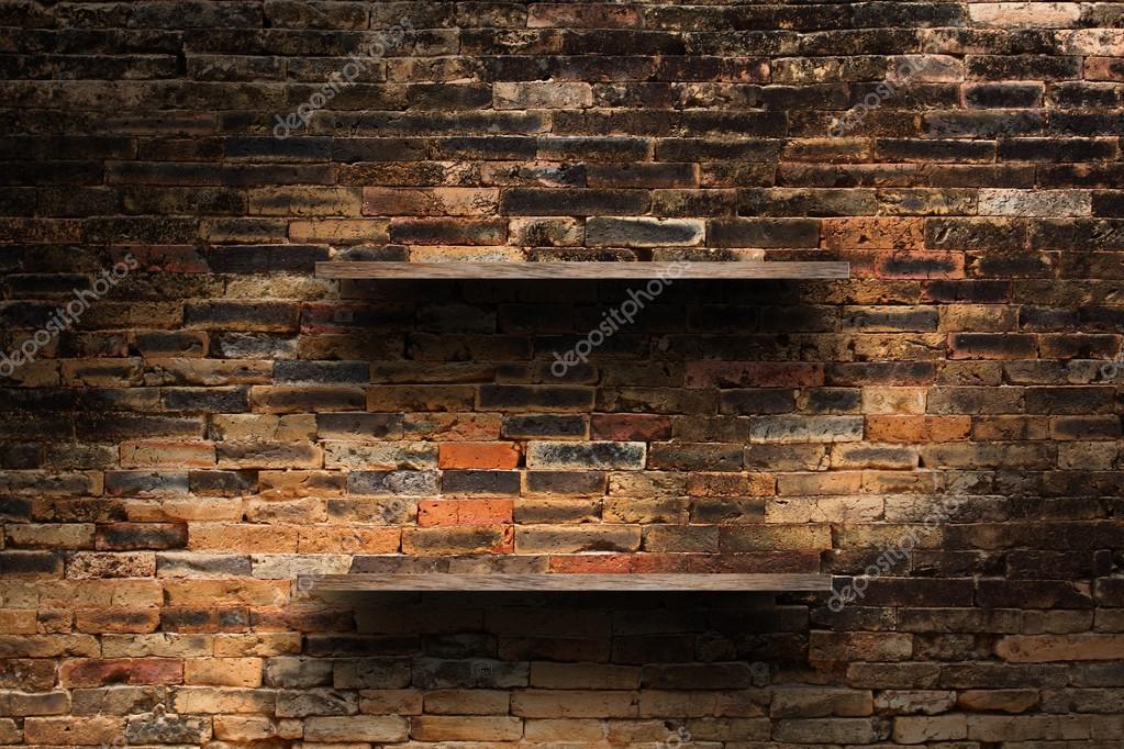 Empty wood shelves on old brick wall background, grunge ...