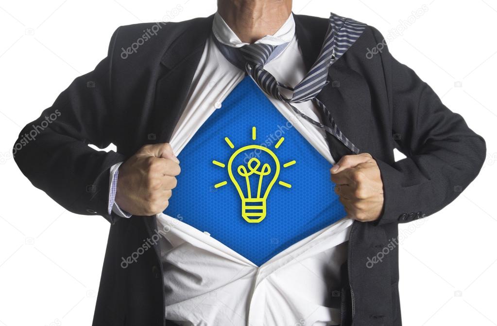 Businessman showing a superhero suit underneath idea light bulb symbol