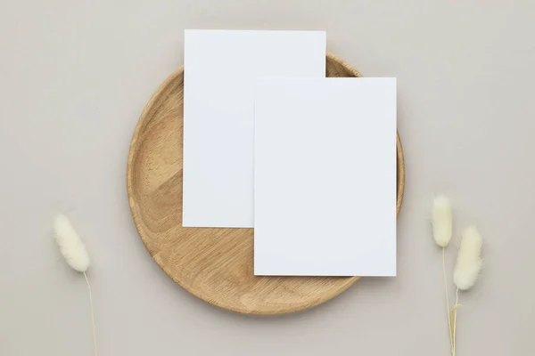 Blank paper cards, Greeting card Mockup with pampas grass on a wooden plate, beige background, Minimal beige workplace composition, flat lay, mockup