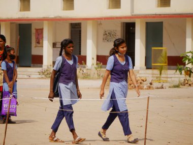 indian government school girl coming together at school premises at motorbike background at day time at city Katni Madhya Pradesh in India on March 2022.
