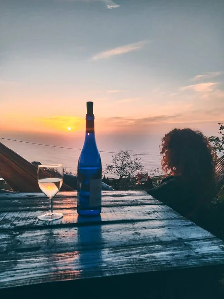 girl drinking wine watching the sunset in a rural house in la palma, canary islands