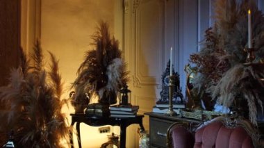  Kitaplar şifoniyerin üzerinde. Kuru çiçekler ve eski çekmecelerin üzerinde kitaplar var.