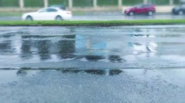 şiddetli yağmur sırasında sular altında asfalt şehir yol. Kiralık Tekerlekler hareket üzerinden püskürtme su