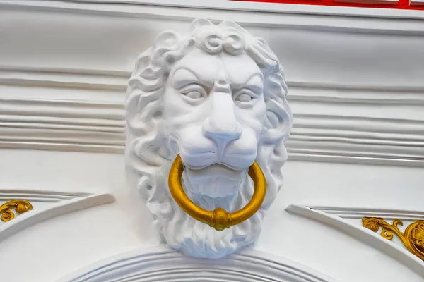 Architectural detail of a lion\'s head on the wall of a building