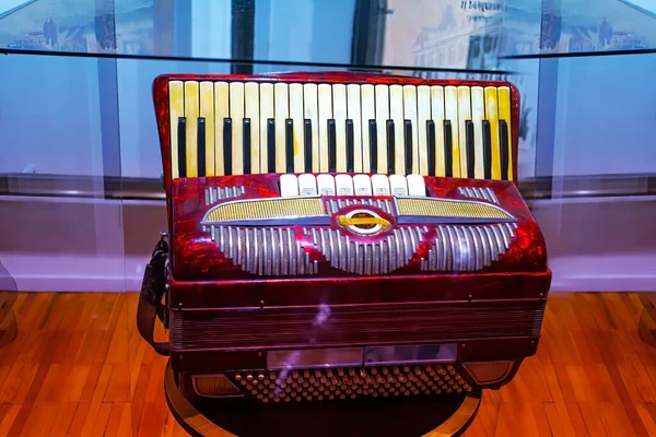 The old rare red accordion . Buttons and keyboard close up view.