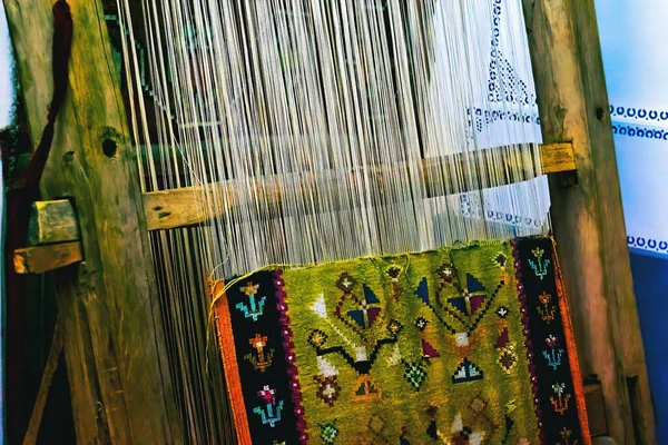 Close up of gold silk weaving on loom, cotton on the manual wood loom in traditional culture