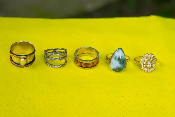 Sterling silver rings on yellow background