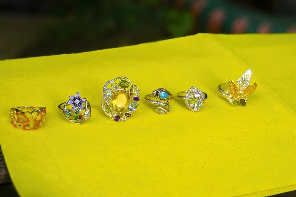 Sterling silver rings on yellow background