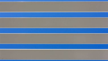 White long pastic slats closeup against blue sky outdoor home awning section abstract background.