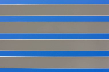 White long pastic slats closeup against blue sky outdoor home awning section abstract background.