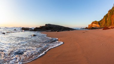 Sahildeki kum suları kıyıdaki dalgalar kayalık kıyı şeridi sabah manzarası..
