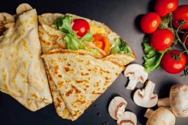 French pancakes dish with ingredients on dark background 