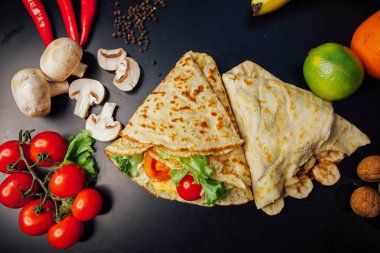 French pancakes dish with ingredients on dark background 