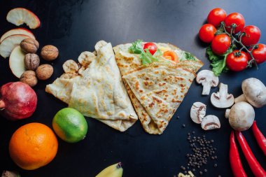 French pancakes dish with ingredients on dark background 