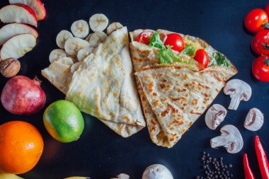 French pancakes dish with ingredients on dark background 