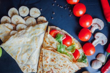 French pancakes dish with ingredients on dark background 