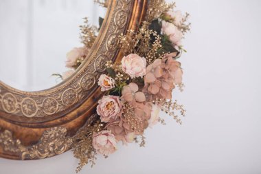 Çerçevede eski aynada pembe çiçekler, stüdyo dekorasyonu.