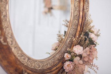 Çerçevede eski aynada pembe çiçekler, stüdyo dekorasyonu.