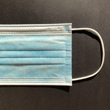 Gri arkaplanda tek kullanımlık yüz maskesi