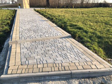 Yeşil bitkilerle dolu bahçe taşı patikası, gündüz vakti tuğla kaldırım. 