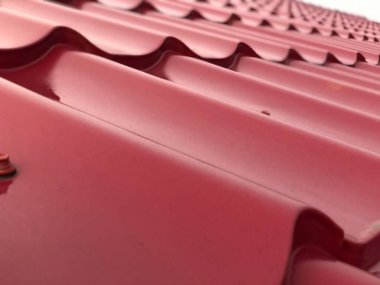 Red tile roof under rain at daytime