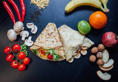 French pancakes dish with ingredients on dark background 