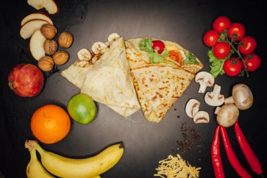 French pancakes dish with ingredients on dark background 