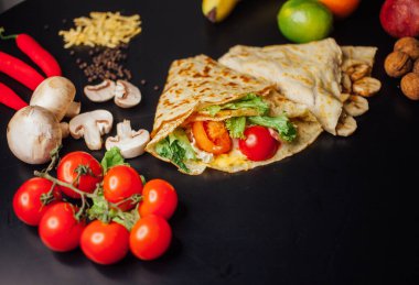 French pancakes dish with ingredients on dark background 